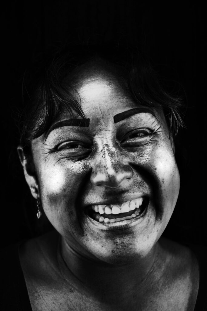 Captivating black and white portrait showcasing a woman's joyful smile in Barranco, Lima.